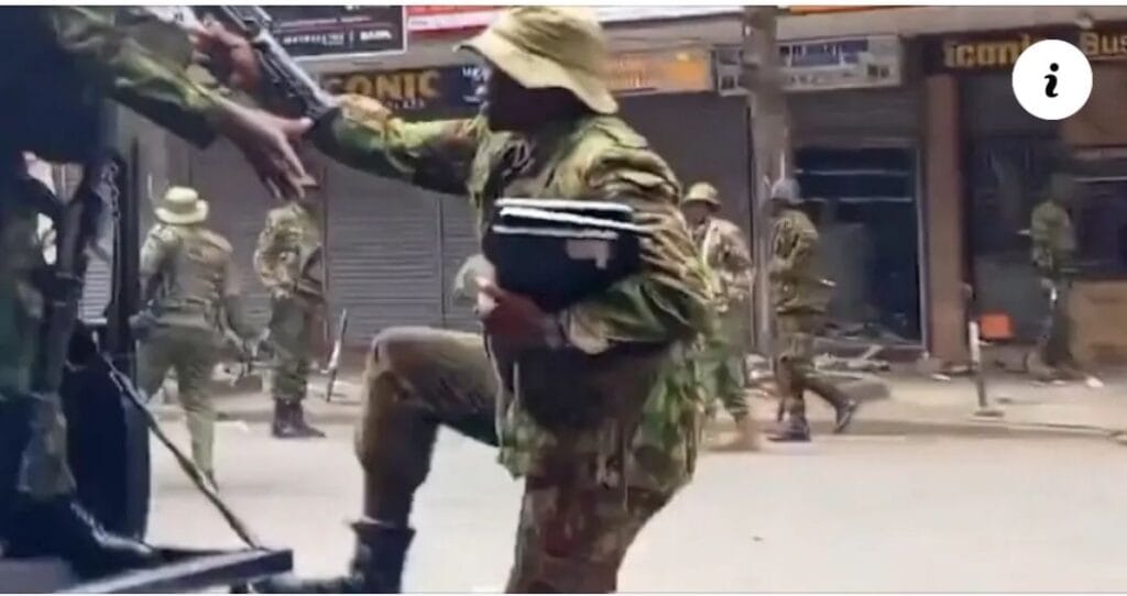 Police officer holding recovered laptops during Nairobi protest unrest