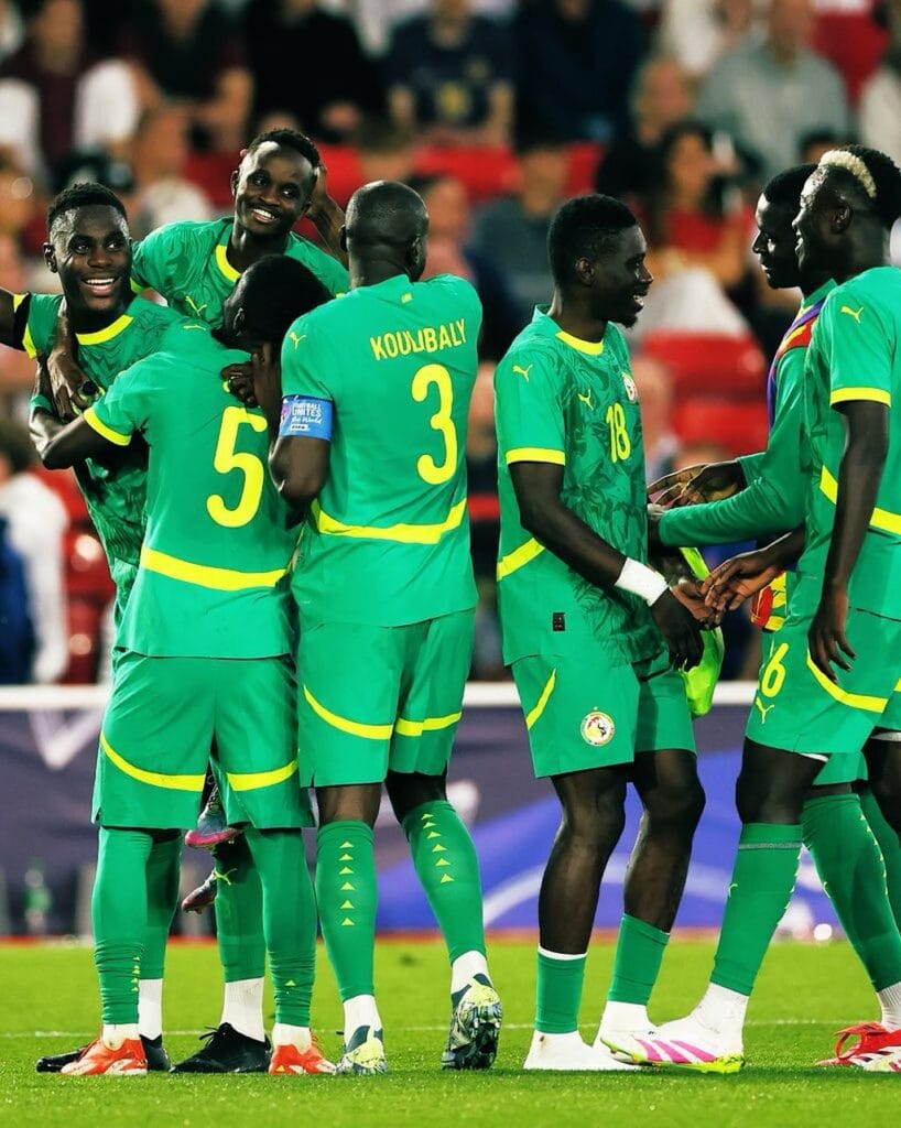 Senegal football players celebrate goal against England at City Ground