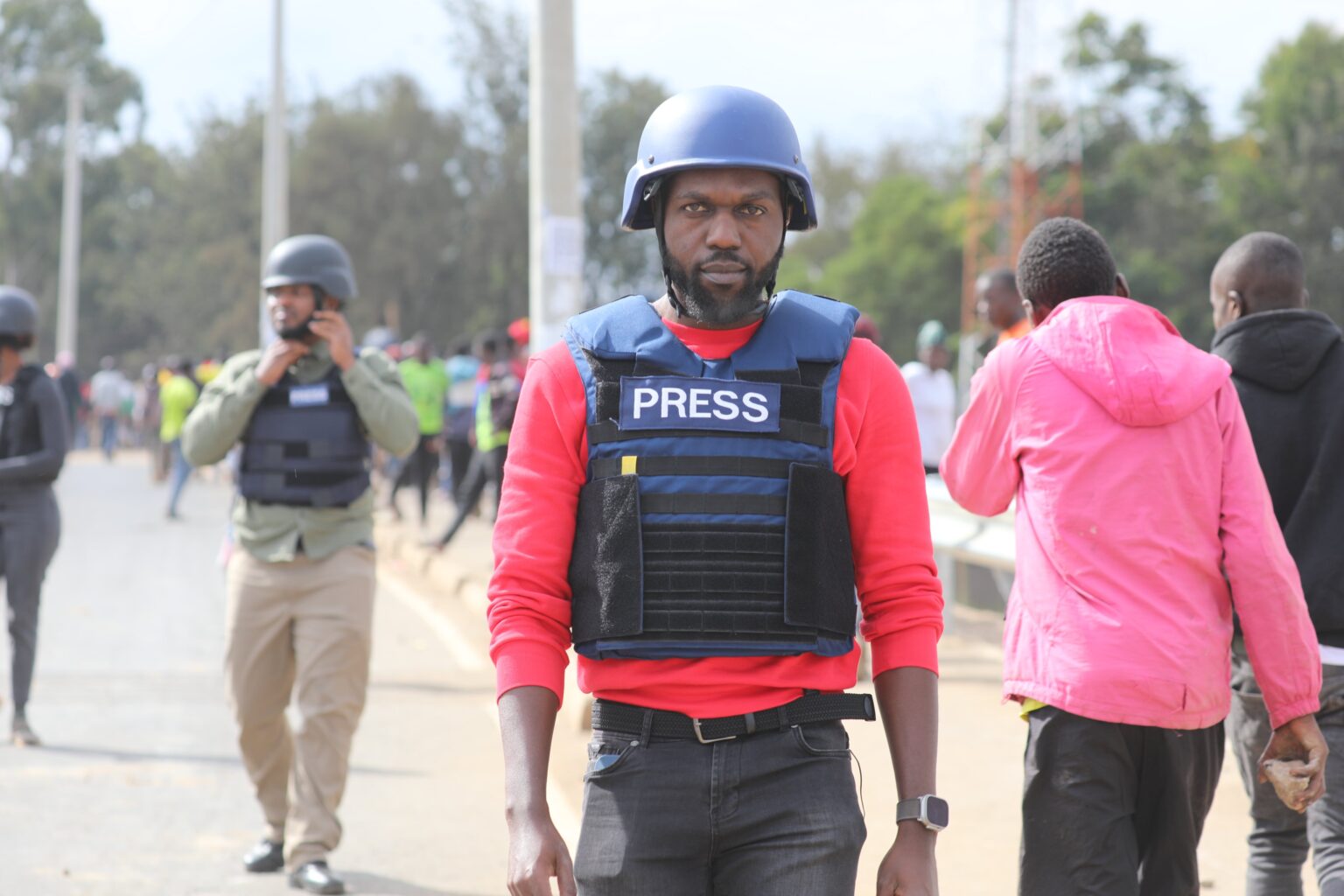 Larry Madowo reporting live from a protest scene